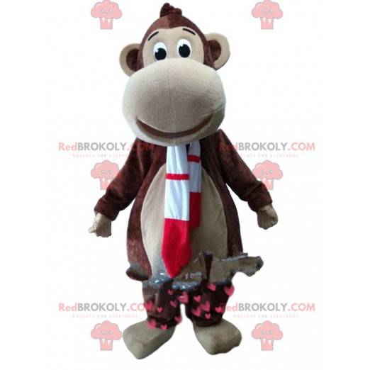 Braunes Affenmaskottchen mit einem roten und weißen Schal -