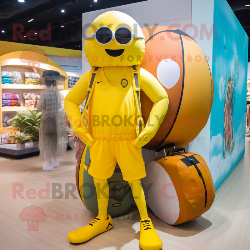 Yellow Basketball Ball mascot costume character dressed with a Swimwear and Messenger bags