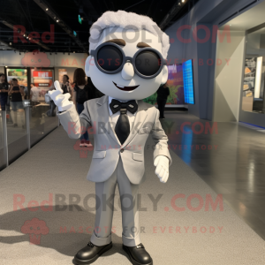 Silver But mascot costume character dressed with a Suit Jacket and Eyeglasses
