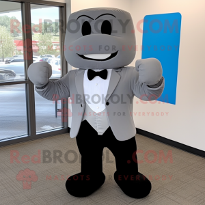 Gray Boxing Glove mascot costume character dressed with a Dress Pants and Bow ties