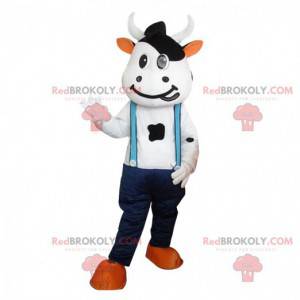 Mascota de vaca con jeans y tirantes. Piel de vaca gigante -