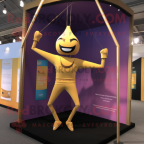 Gold Trapeze Artist mascot costume character dressed with a Yoga Pants and Tie pins