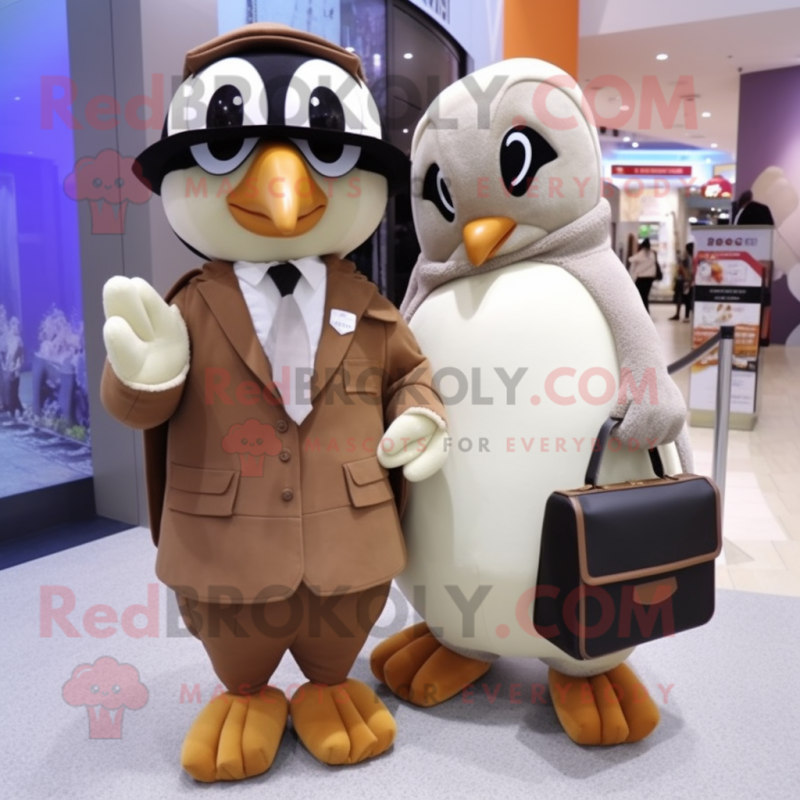 Tan Penguin mascot costume character dressed with a Blouse and Clutch bags