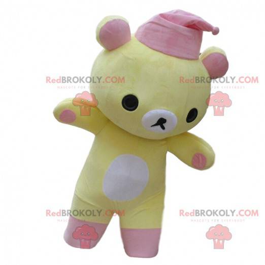 Geel en wit teddybeer mascotte met een roze slaapmutsje -