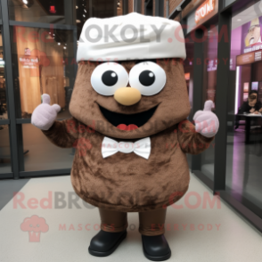 Brown Cupcake mascot costume character dressed with a Vest and Hats