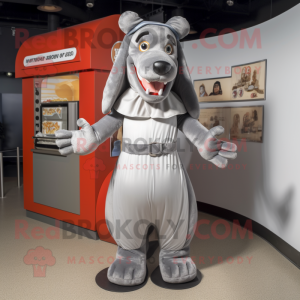 Silver Hot Dogs mascot costume character dressed with a Cover-up and Suspenders