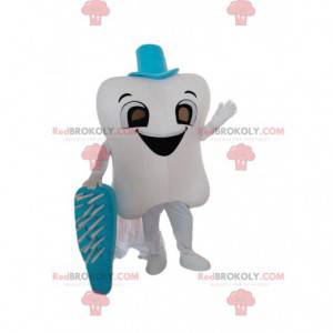 Mascotte de dent blanche géante avec une brosse à dents bleue -