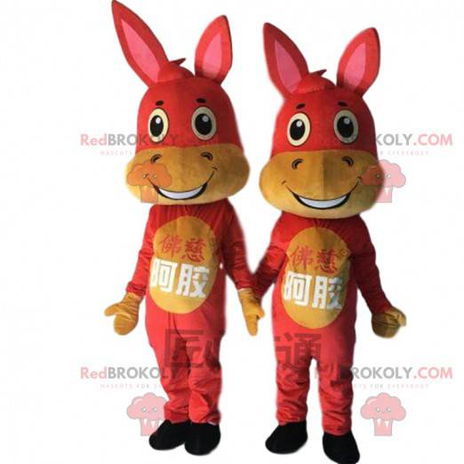 2 mascottes d'ânes rouges et jaunes, costumes de bourriques -