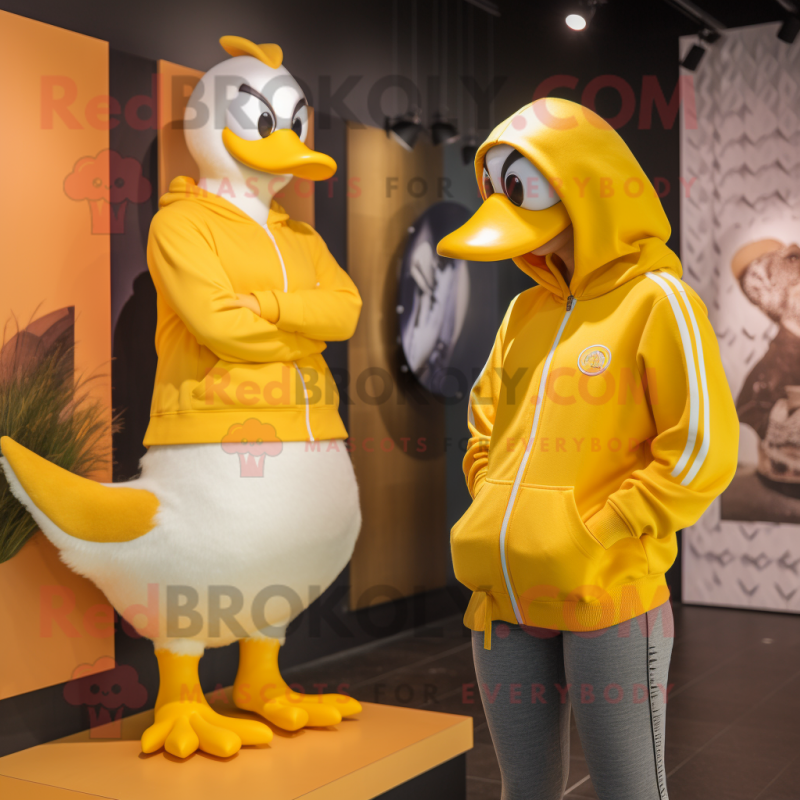 Yellow Swans mascot costume character dressed with a Sweatshirt and Watches Yellow Swans mascot costume character dressed with a Sweatshirt and Watches
