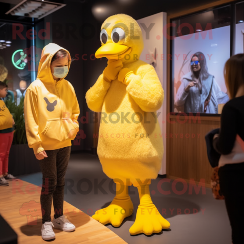 Yellow Swans mascot costume character dressed with a Sweatshirt and Watches