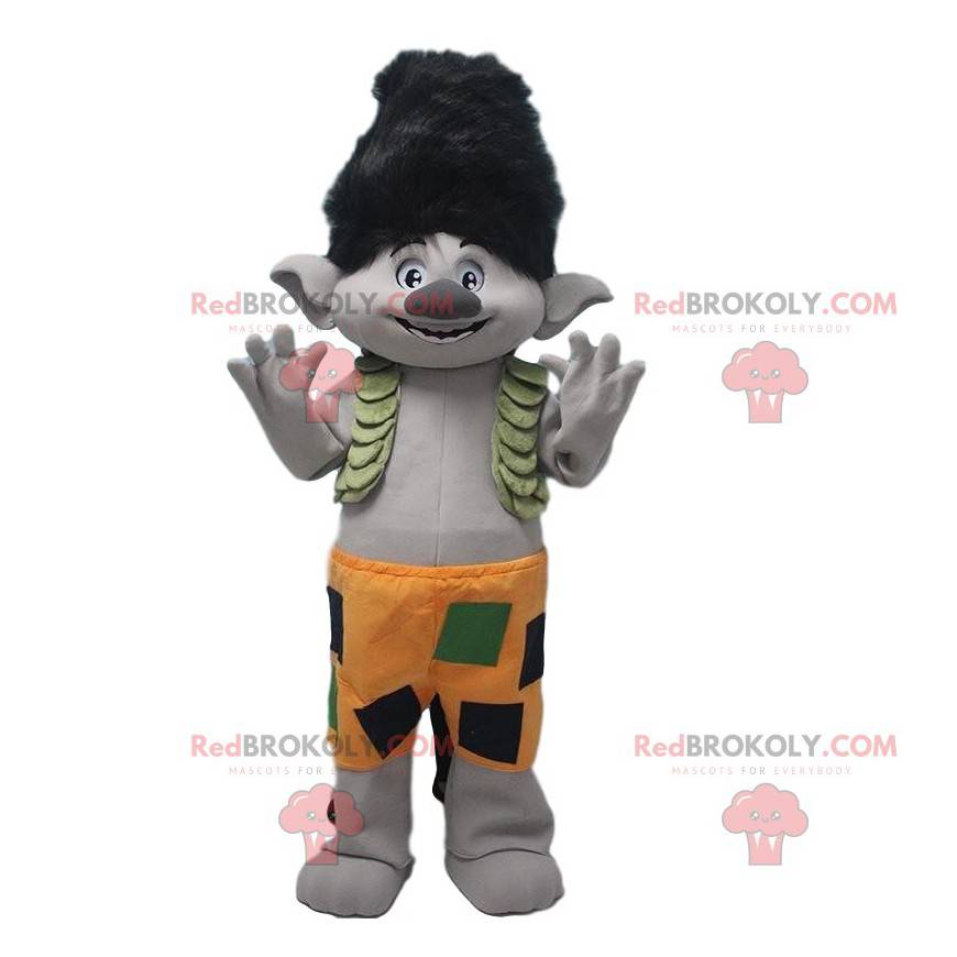 Mascota troll gris con pelo negro y pantalones cortos naranjas