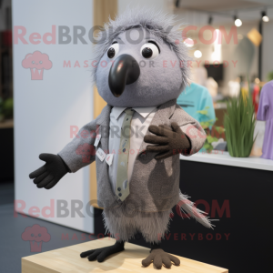 Gray Kiwi mascot costume character dressed with a Dress Shirt and Hairpins