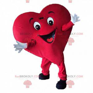 Mascota de corazón rojo gigante, traje romántico y sonriente -
