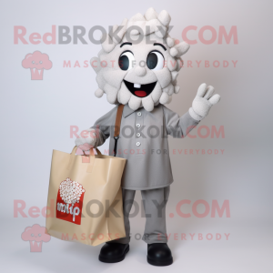 Silver Pop Corn mascot costume character dressed with a Button-Up Shirt and Tote bags