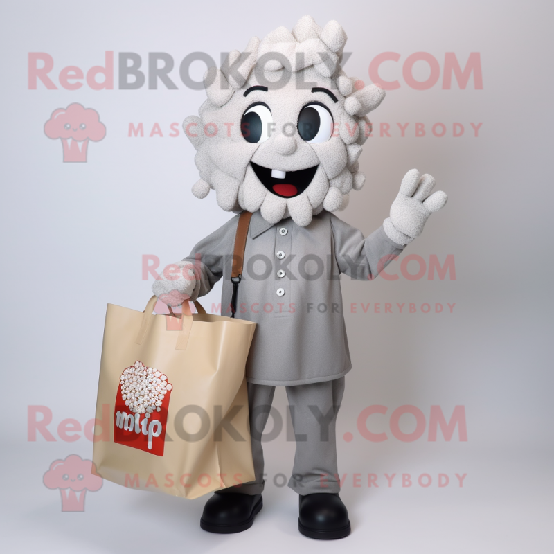 Silver Pop Corn mascot costume character dressed with a Button-Up Shirt and Tote bags