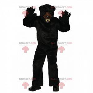 Hård maskot med sort bjørn, skræmmende behåret bjørnekostume -