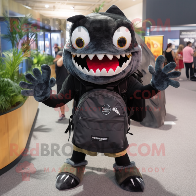 Black Piranha mascot costume character dressed with a Graphic Tee and Backpacks