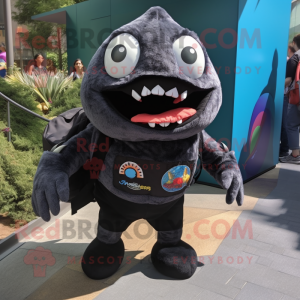 Black Piranha mascot costume character dressed with a Graphic Tee and Backpacks