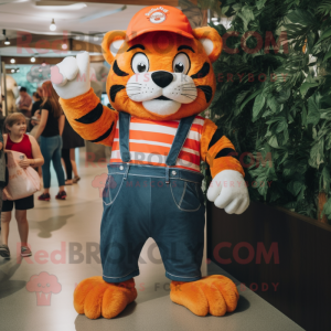 Orange Tiger mascot costume character dressed with a Mom Jeans and Caps