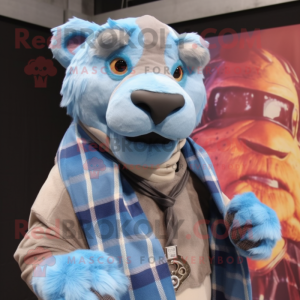 Sky Blue Smilodon mascot costume character dressed with a Flannel Shirt and Shawl pins
