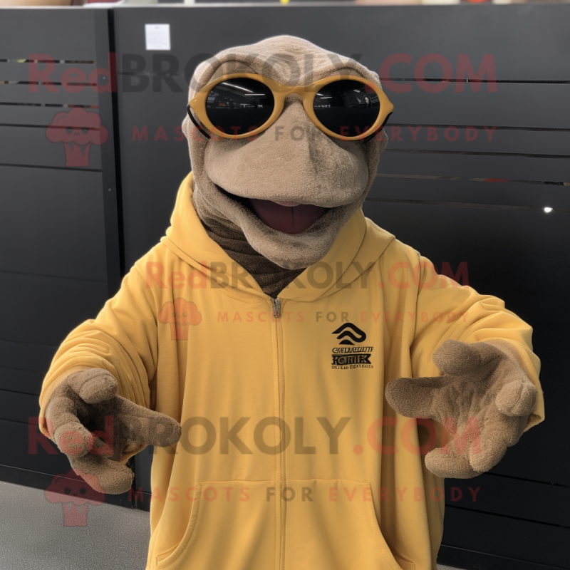 Tan Komodo Dragon mascot costume character dressed with a Sweatshirt and Eyeglasses