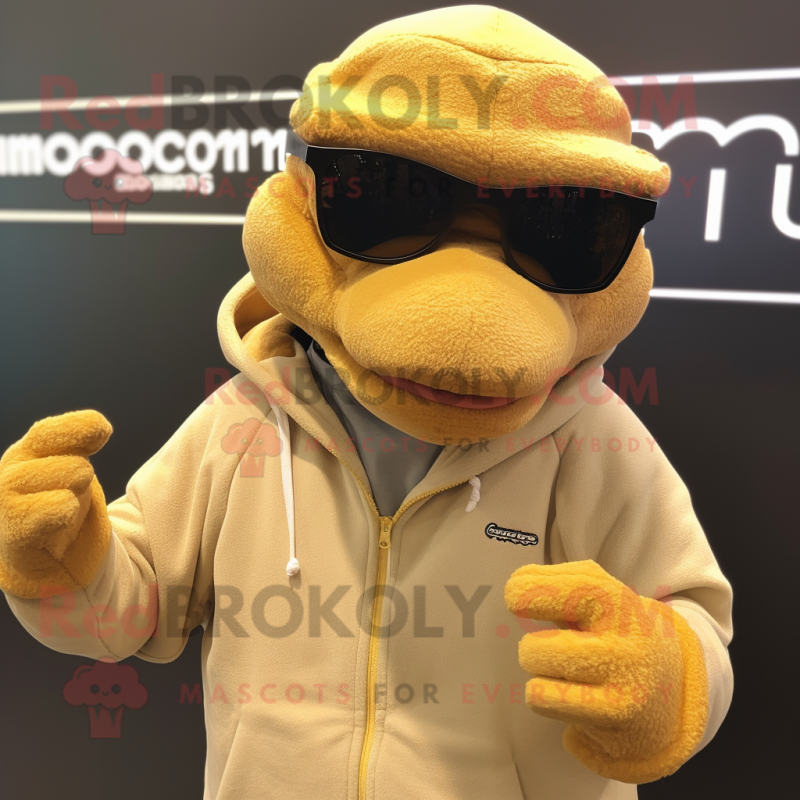 Tan Komodo Dragon mascot costume character dressed with a Sweatshirt and Eyeglasses Tan Komodo Dragon mascot costume character dressed with a Sweatshirt and Eyeglasses