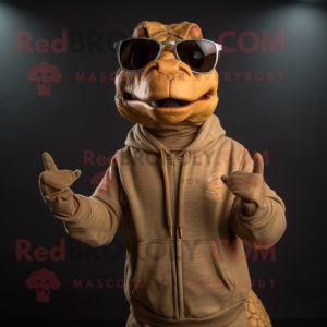 Tan Komodo Dragon mascot costume character dressed with a Sweatshirt and Eyeglasses