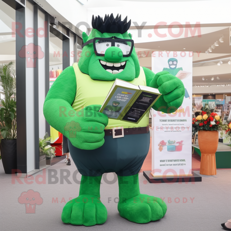 Green Strongman mascot costume character dressed with a Shift Dress and Reading glasses