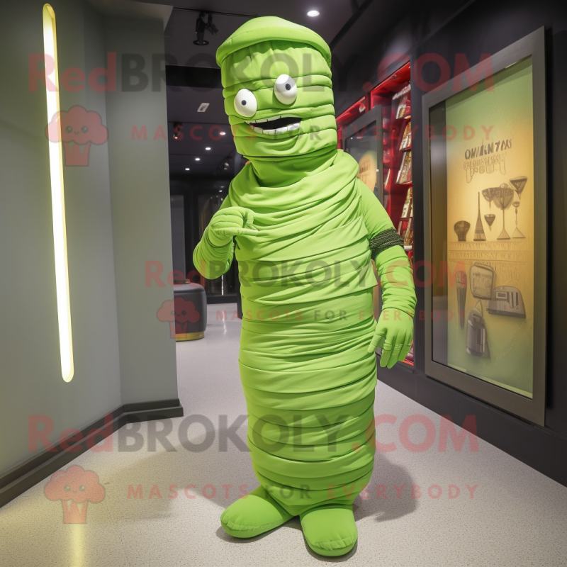 Lime Green Mummy mascot costume character dressed with a Evening Gown and Messenger bags