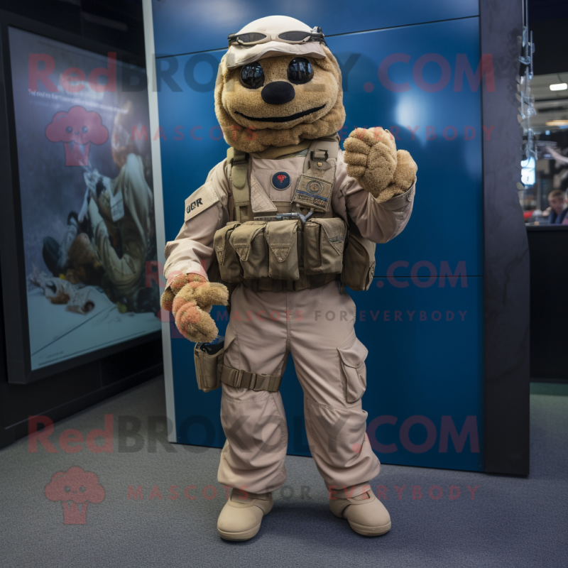 Tan Marine Recon mascot costume character dressed with a Dungarees and Scarves Tan Marine Recon mascot costume character dressed with a Dungarees and Scarves