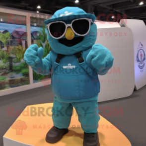 Turquoise Marine Recon mascot costume character dressed with a Board Shorts and Sunglasses