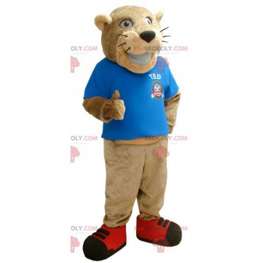 Beige Tiger Maskottchen mit einem blauen T-Shirt -