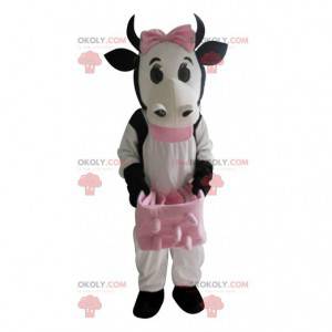 Mascotte de vache blanche et noire avec les pies rose -