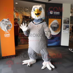 Silver Haast'S Eagle mascot costume character dressed with a T-Shirt and Rings