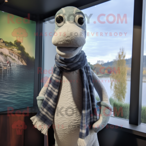 Silver Loch Ness Monster mascot costume character dressed with a Graphic Tee and Scarves