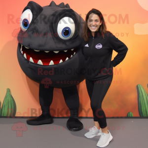 Black Piranha mascot costume character dressed with a Yoga Pants and Shoe clips