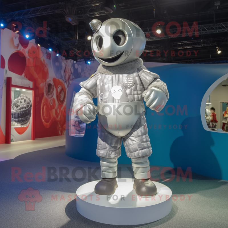 Silver Rugby Ball mascot costume character dressed with a Romper and Wraps Silver Rugby Ball mascot costume character dressed with a Romper and Wraps