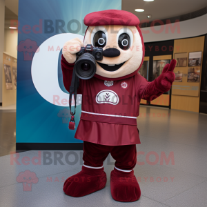 Maroon Camera mascot costume character dressed with a Chinos and Foot pads