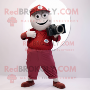 Maroon Camera mascot costume character dressed with a Chinos and Foot pads