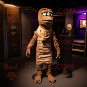 Brown Mummy mascot costume character dressed with a Jacket and Anklets