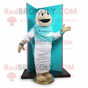 Cyan Mummy mascot costume character dressed with a Board Shorts and Shawl pins