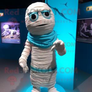 Cyan Mummy mascot costume character dressed with a Board Shorts and Shawl pins