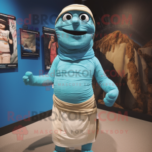 Cyan Mummy mascot costume character dressed with a Board Shorts and Shawl pins