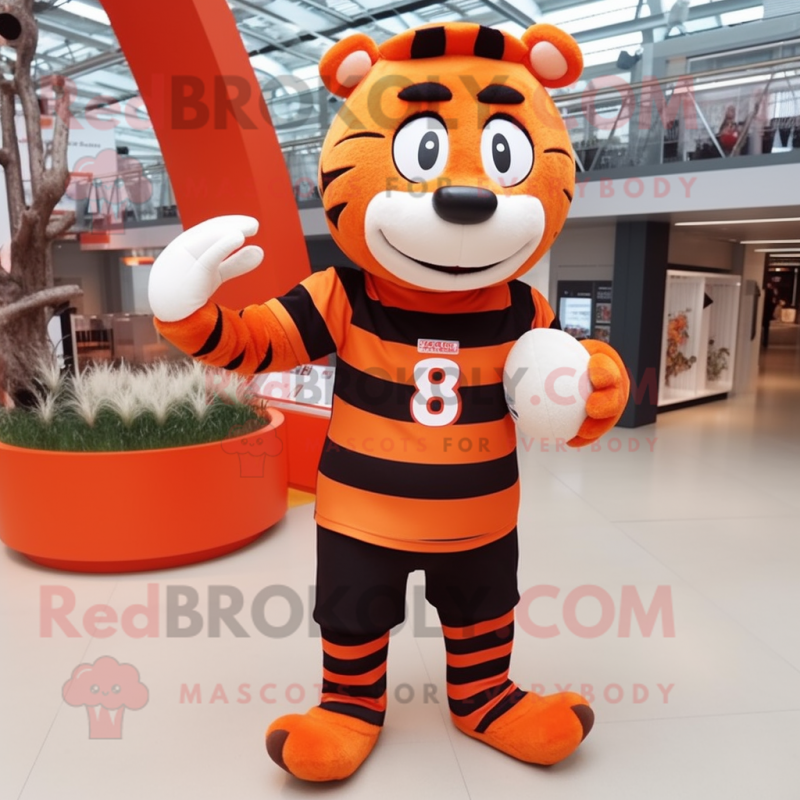 Orange Zebra mascot costume character dressed with a Rugby Shirt and Beanies