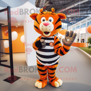 Orange Zebra mascot costume character dressed with a Rugby Shirt and Beanies