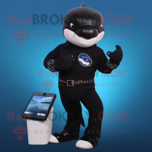 Black Killer Whale mascot costume character dressed with a Chinos and Digital watches