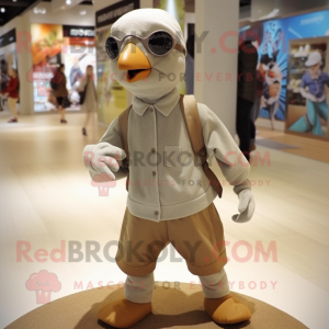 Tan Pigeon mascot costume character dressed with a Dress Pants and Beanies
