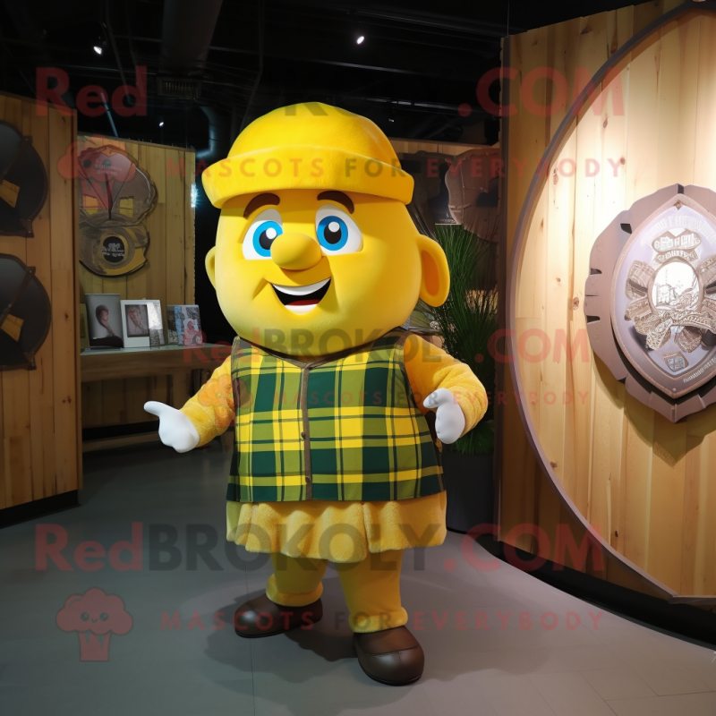 Yellow Celtic Shield mascot costume character dressed with a Flannel Shirt and Caps Yellow Celtic Shield mascot costume character dressed with a Flannel Shirt and Caps