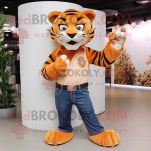 Peach Saber-Toothed Tiger mascot costume character dressed with a Bootcut Jeans and Bracelet watches