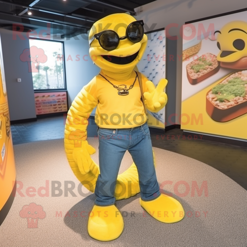 Yellow Anaconda mascot costume character dressed with a Dungarees and Sunglasses Yellow Anaconda mascot costume character dressed with a Dungarees and Sunglasses